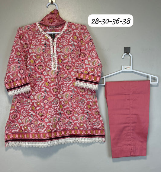 Pink patterned top and pants on hangers against a gray background