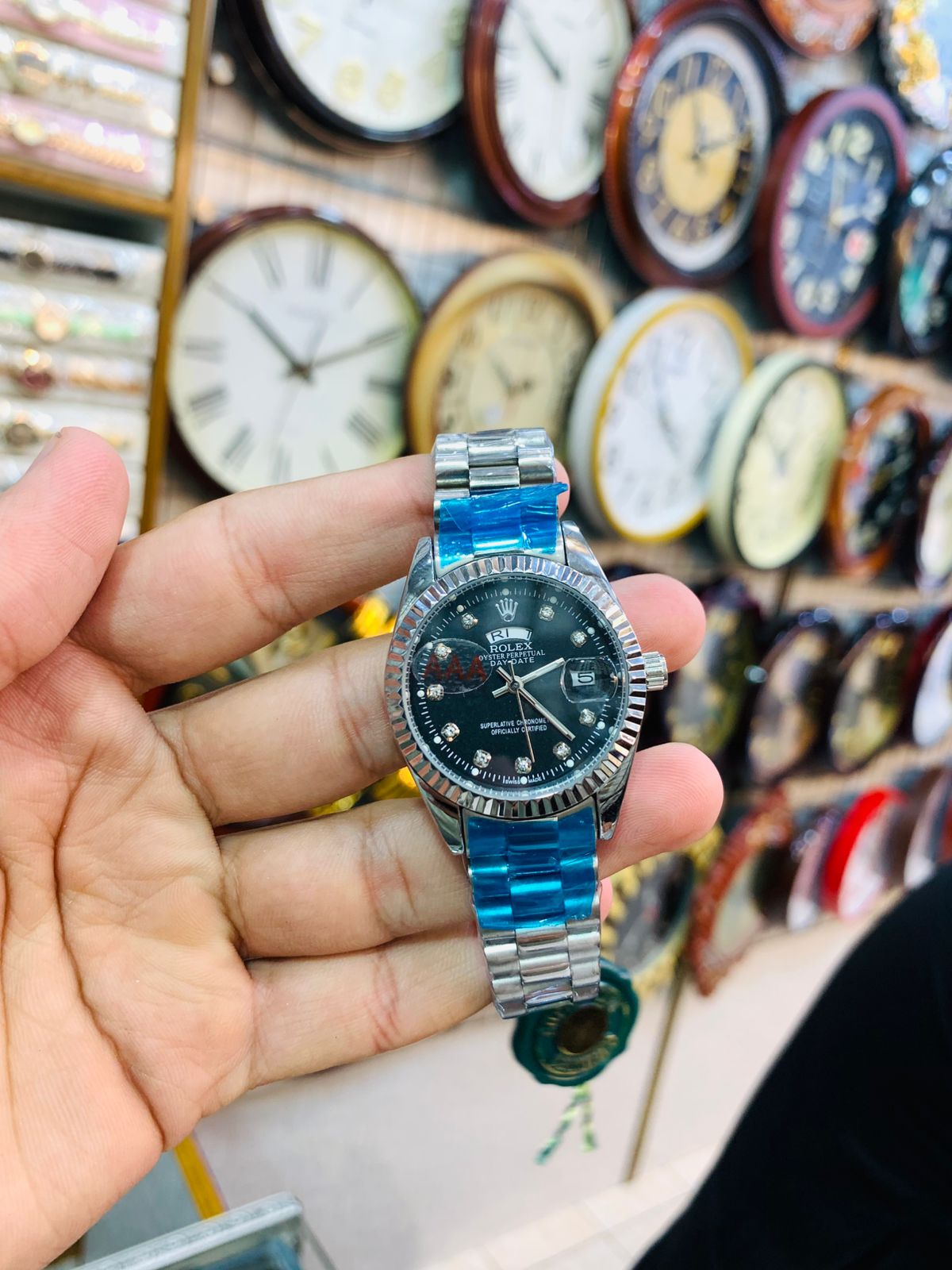 Stylish silver ladies wrist watch with black dial and stainless steel bracelet.