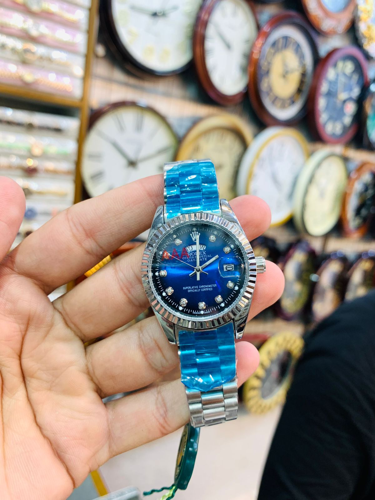 Luxury ladies silver wrist watch with elegant blue dial and diamond-style markers.