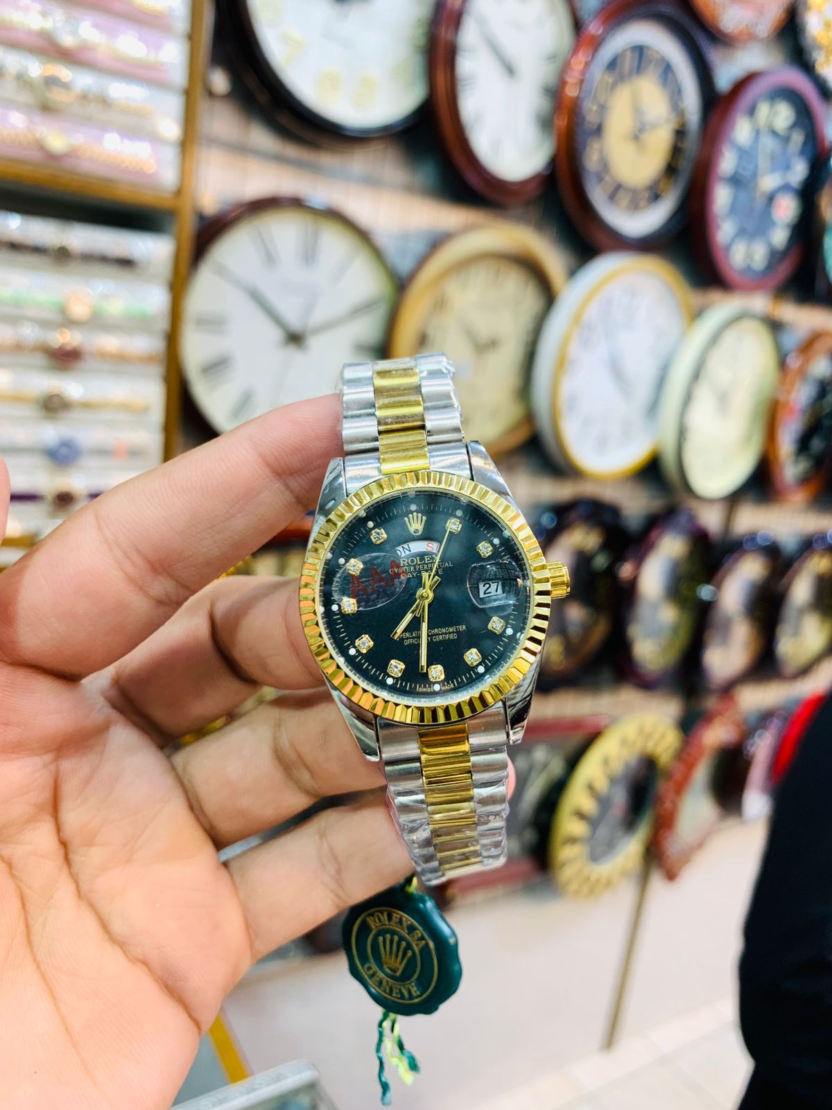 Two-tone ladies wrist watch with black dial, stainless steel, and gold accents.