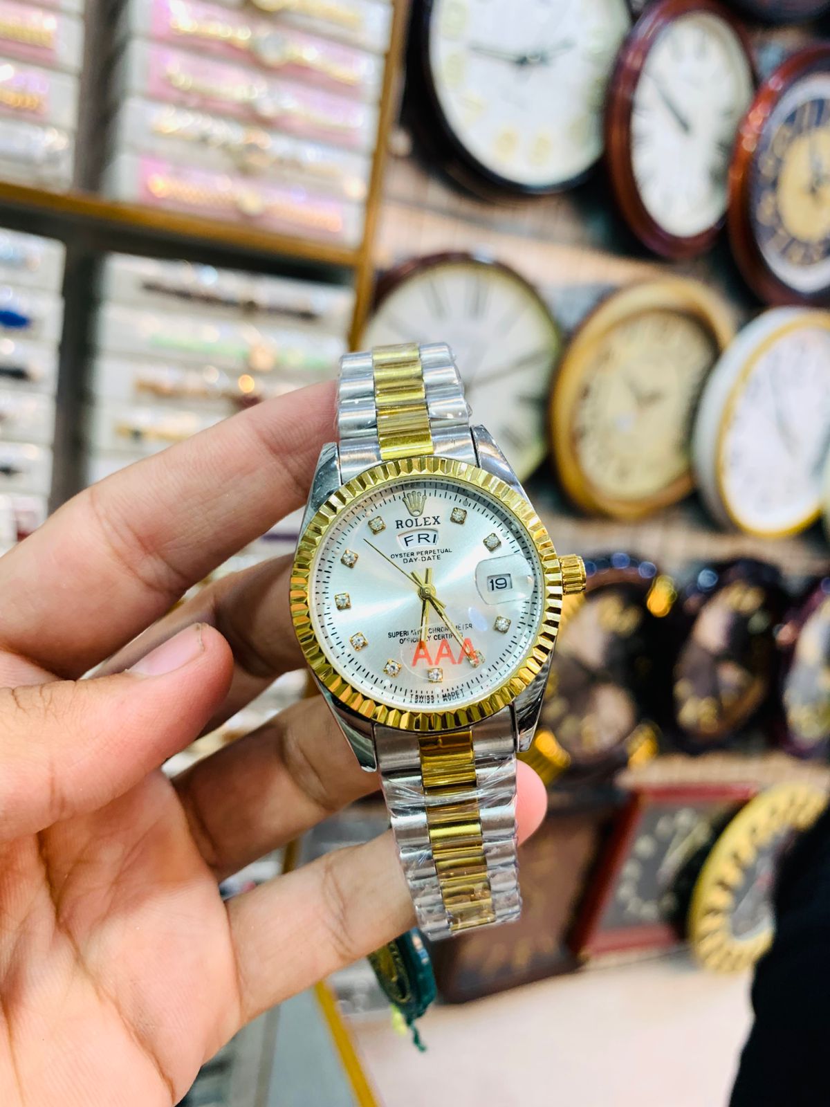 Elegant two-tone ladies wrist watch with white dial and gold-silver strap.