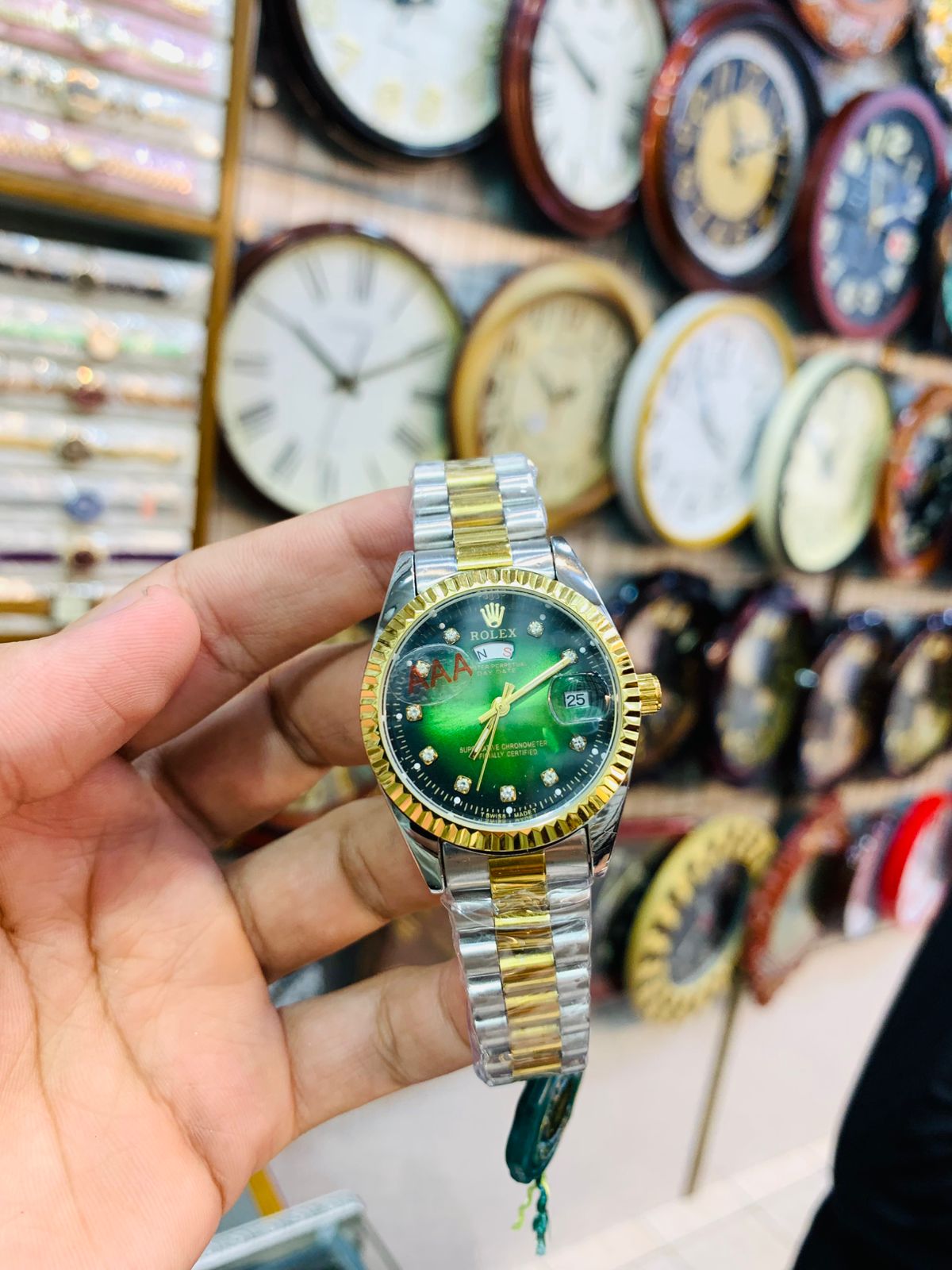 Elegant two-tone ladies wrist watch with green dial and gold-silver bracelet.